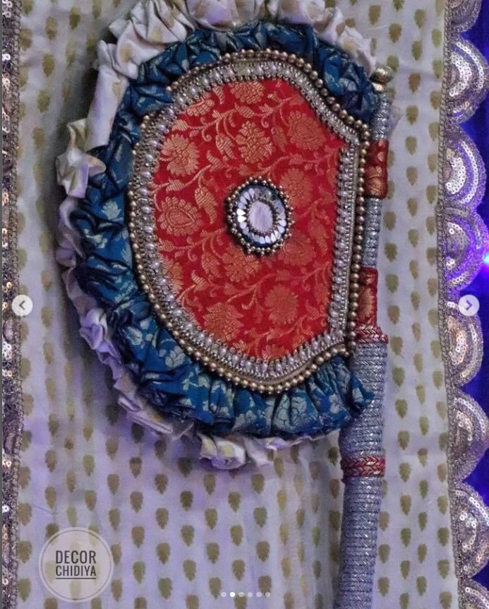 Maroon and teal Beejana or handfan in Banarasi fabric and mirrorwork detail
