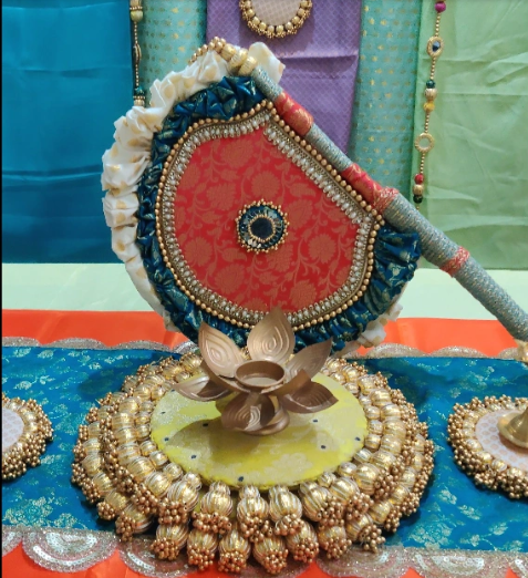 Maroon and teal Beejana or handfan in Banarasi fabric and mirrorwork detail